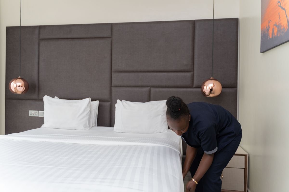 Hotel housekeeper preparing an upscale room